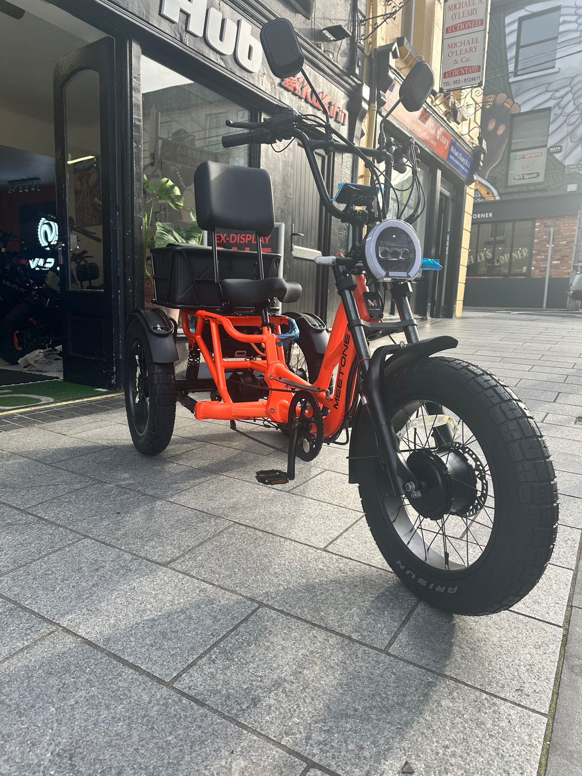 Front side view of the Meet One Tour 2.0 electric trike on an Irish street.